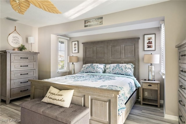 bedroom with ceiling fan and light hardwood / wood-style floors