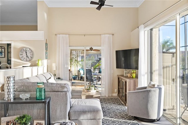 living room featuring ornamental molding and ceiling fan