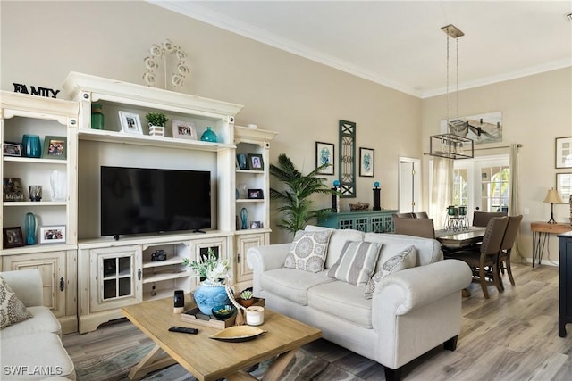 living room featuring ornamental molding and light wood-type flooring