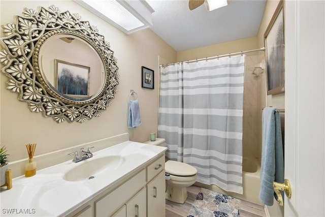 full bathroom featuring hardwood / wood-style flooring, shower / tub combo with curtain, vanity, and toilet