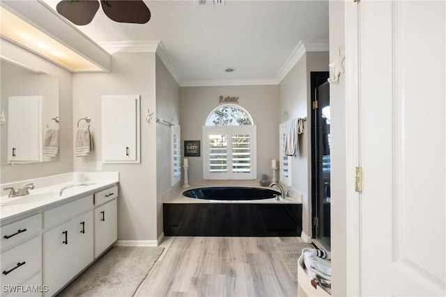 bathroom with vanity, ornamental molding, hardwood / wood-style floors, and plus walk in shower