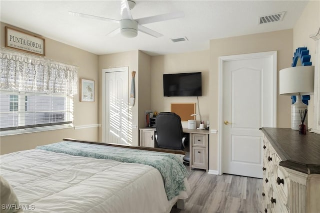 bedroom featuring light wood-type flooring, ceiling fan, and a closet