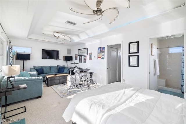 bedroom featuring a tray ceiling, ceiling fan, and carpet flooring