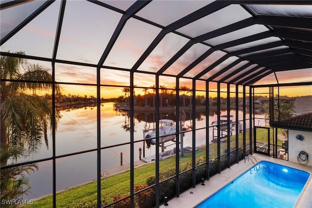 pool at dusk with glass enclosure and a water view