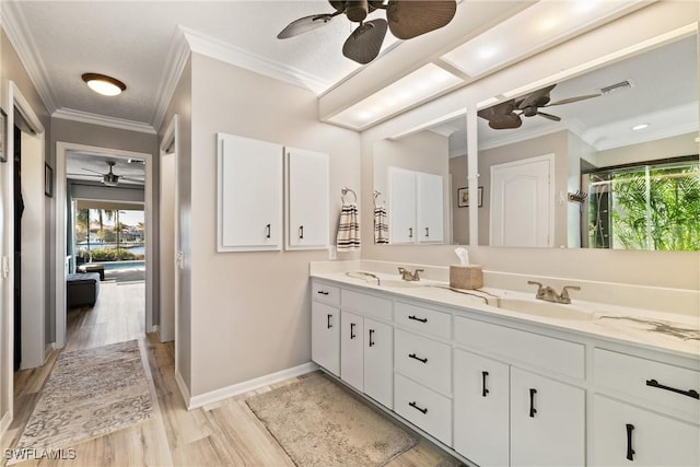 bathroom with vanity, hardwood / wood-style floors, ceiling fan, and crown molding