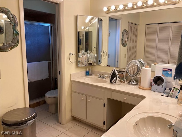 bathroom with vanity, an enclosed shower, tile patterned floors, and toilet