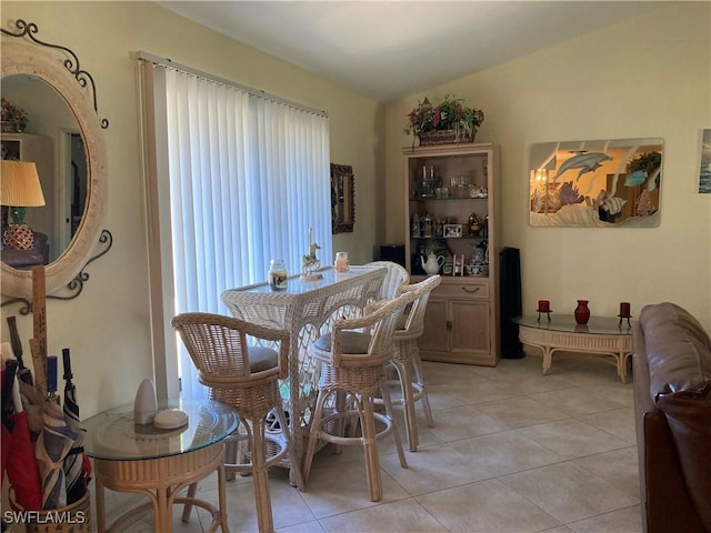 dining room with vaulted ceiling and light tile patterned flooring