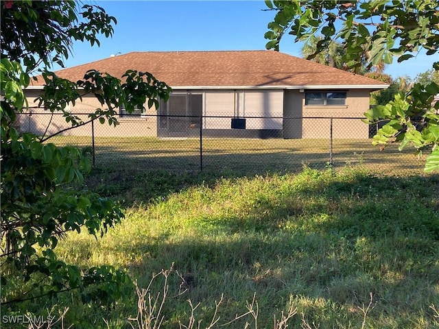 view of front of home featuring a lawn, fence, and stucco siding