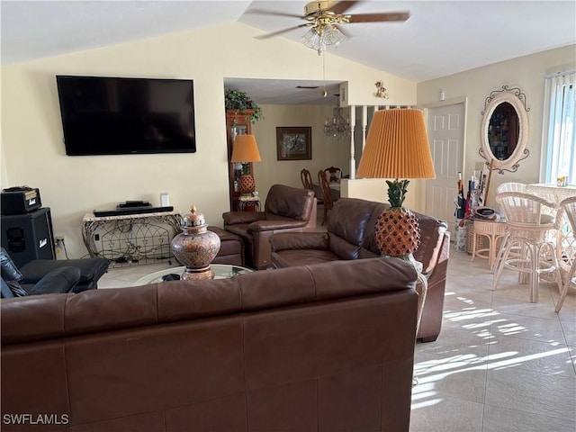 living room featuring ceiling fan, vaulted ceiling, and light tile patterned flooring