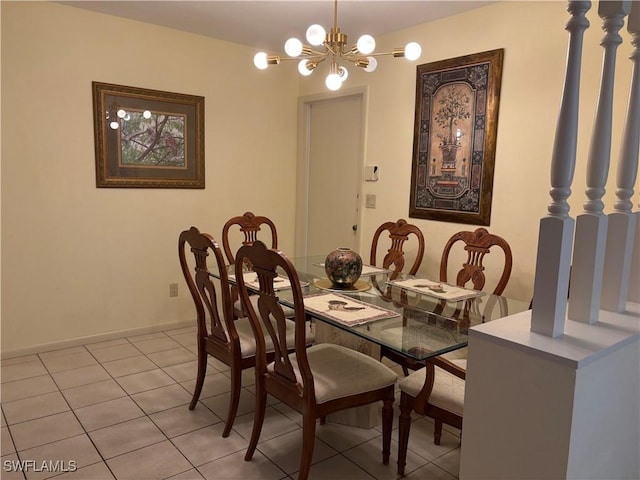 dining space with light tile patterned floors, a chandelier, and baseboards