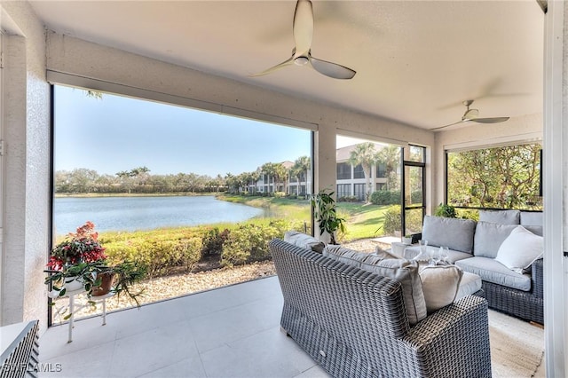 sunroom / solarium with ceiling fan and a water view