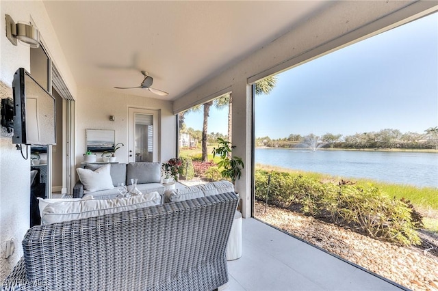 view of patio featuring an outdoor hangout area, ceiling fan, and a water view