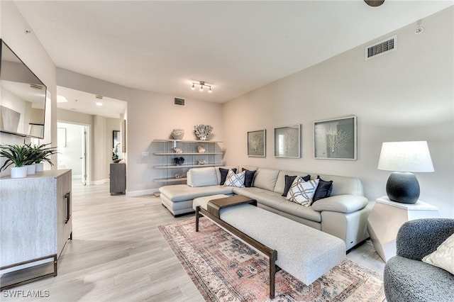 living room with light hardwood / wood-style flooring