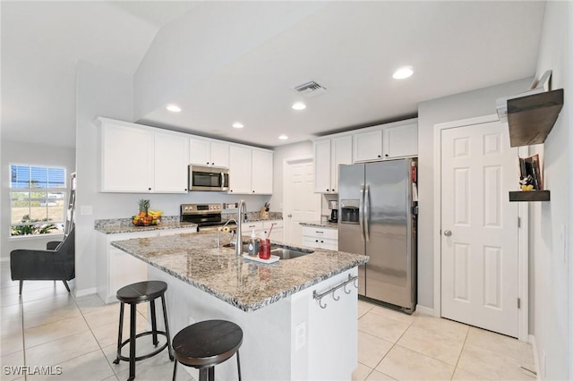 kitchen featuring white cabinetry, appliances with stainless steel finishes, sink, and a center island with sink