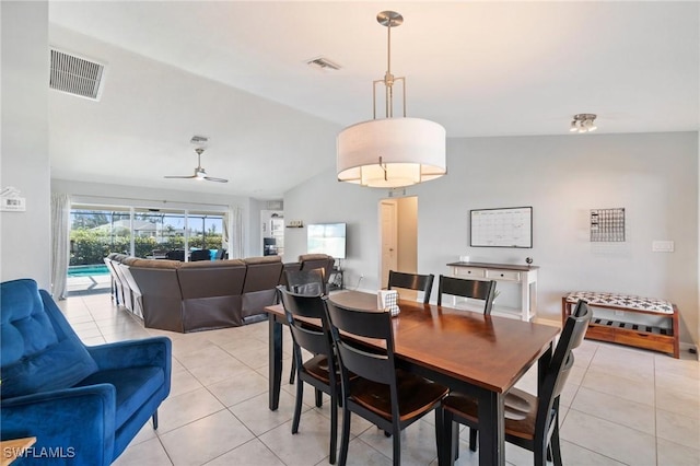 dining area with lofted ceiling, ceiling fan, and light tile patterned flooring