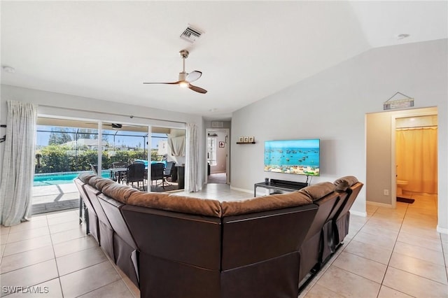 tiled living room with lofted ceiling and ceiling fan