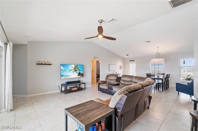 living room featuring vaulted ceiling, light tile patterned floors, and ceiling fan