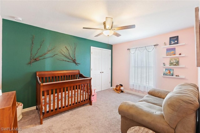 carpeted bedroom featuring ceiling fan and a closet