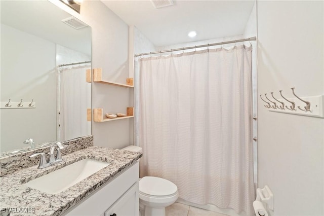 bathroom with vanity, tile patterned flooring, and toilet