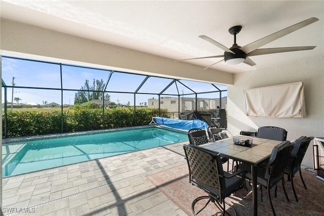 view of swimming pool featuring a lanai, a patio, and ceiling fan