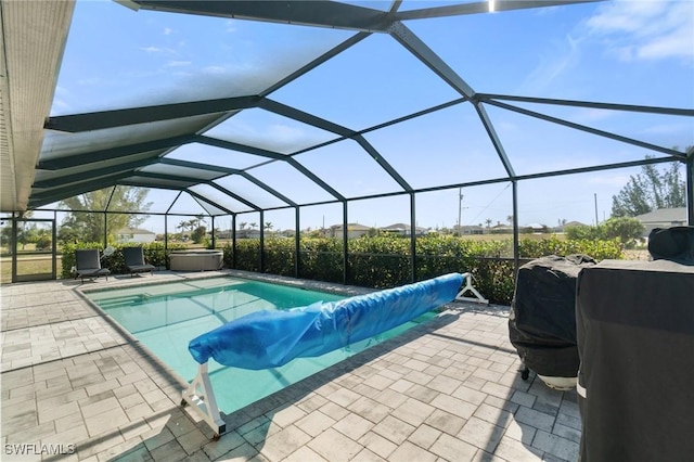 view of pool with a patio, a lanai, and a jacuzzi