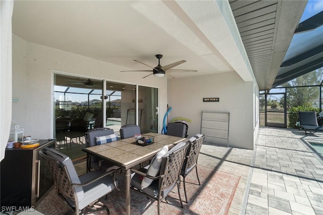 view of patio / terrace with ceiling fan and a lanai