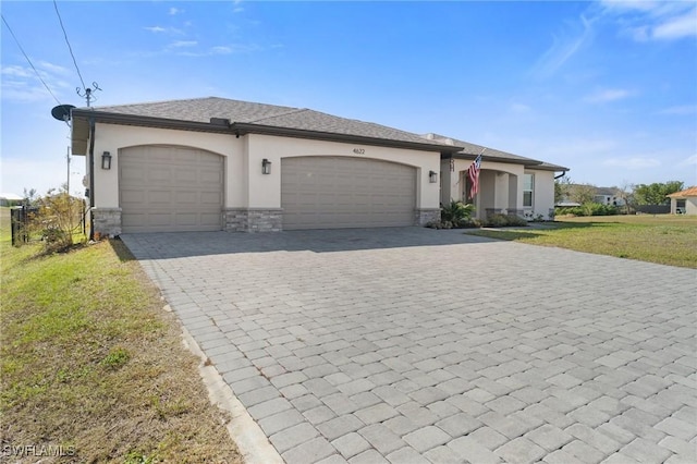 single story home with a garage and a front lawn