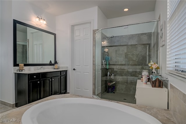 bathroom featuring shower with separate bathtub and vanity