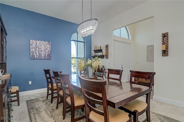 dining room with light tile patterned floors and a notable chandelier