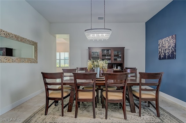 dining room featuring an inviting chandelier and light tile patterned floors