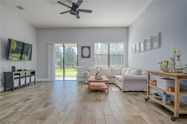 living room featuring ceiling fan and plenty of natural light