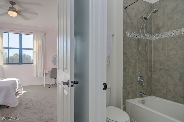 bathroom with toilet and tiled shower / bath combo