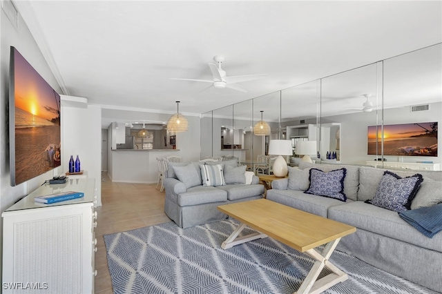 living room with ceiling fan and light tile patterned flooring