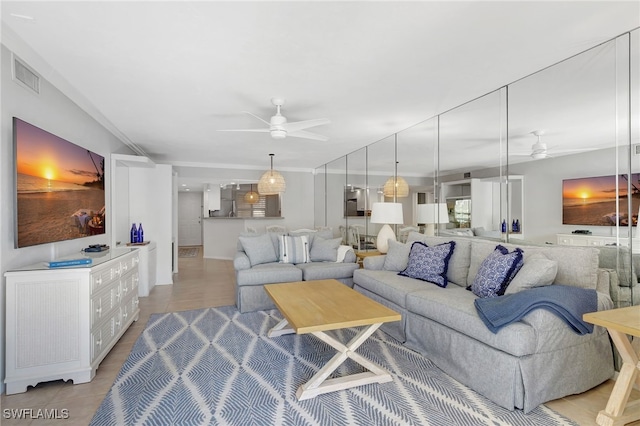 living room featuring light tile patterned flooring and ceiling fan