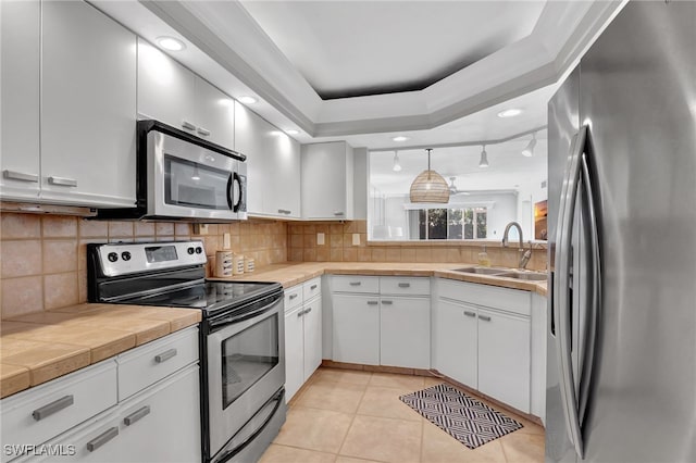 kitchen with white cabinetry, stainless steel appliances, and sink