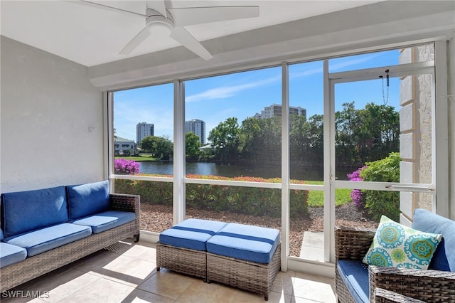 sunroom featuring a water view, a wealth of natural light, and ceiling fan