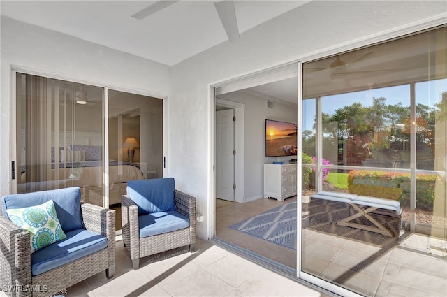 sunroom / solarium featuring ceiling fan