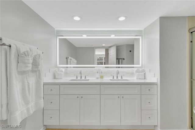 bathroom with vanity and decorative backsplash