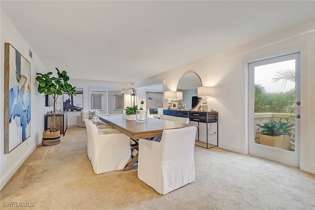 dining area featuring light colored carpet