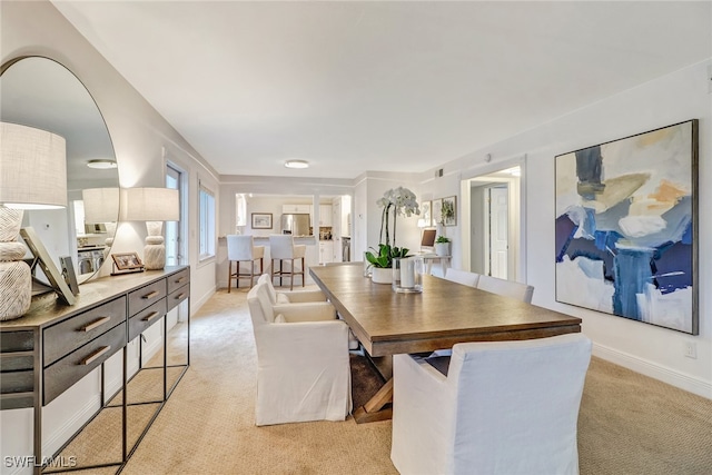 dining area with light colored carpet