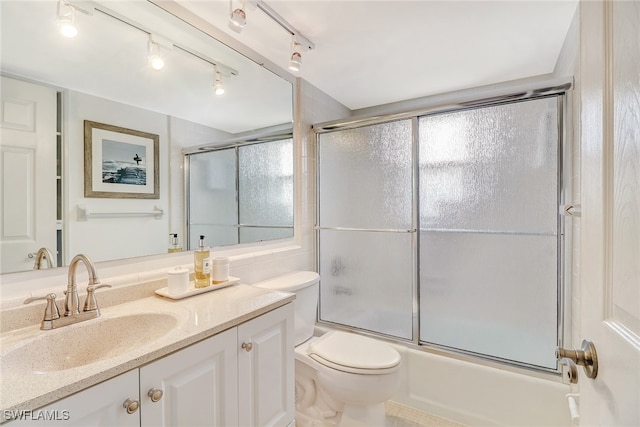 full bathroom with vanity, toilet, and combined bath / shower with glass door