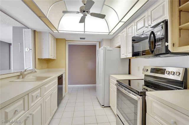 kitchen with sink, white cabinetry, light tile patterned floors, ceiling fan, and black appliances