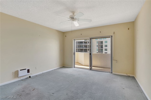 empty room with a textured ceiling, light colored carpet, and ceiling fan