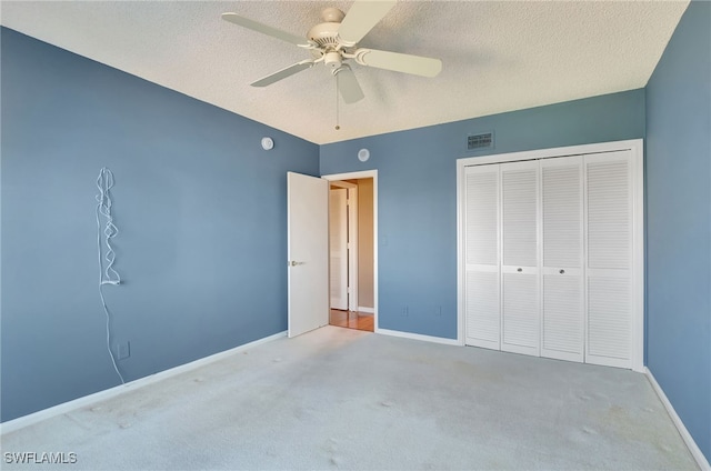 unfurnished bedroom with carpet flooring, ceiling fan, and a closet