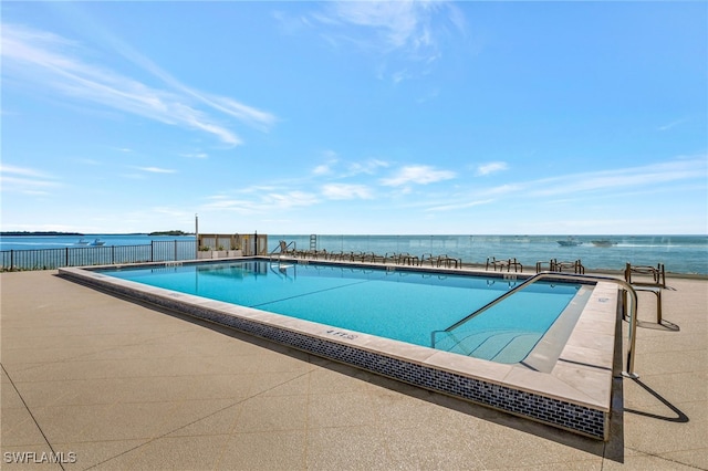 view of pool with a water view