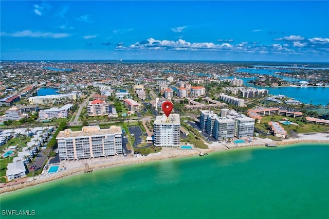 drone / aerial view featuring a water view and a beach view