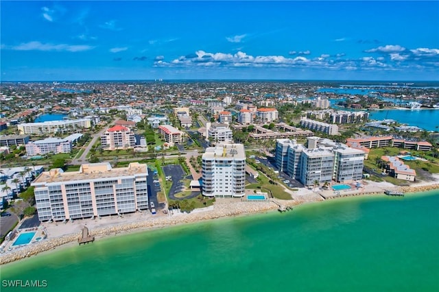 drone / aerial view with a water view and a beach view