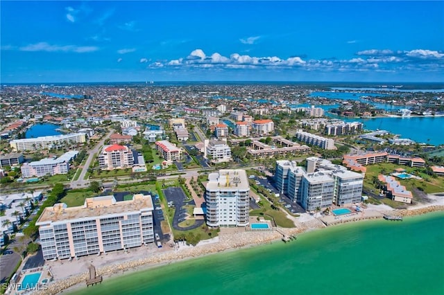 birds eye view of property featuring a water view and a beach view