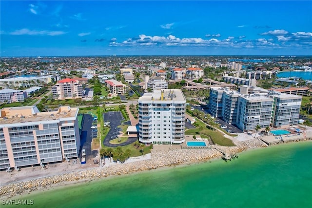 birds eye view of property with a view of the beach and a water view