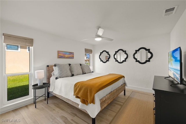 bedroom with light hardwood / wood-style flooring and ceiling fan